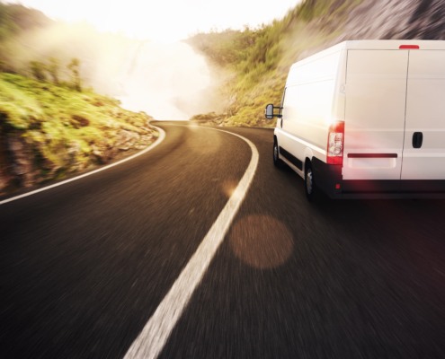 delivery van driving along a road